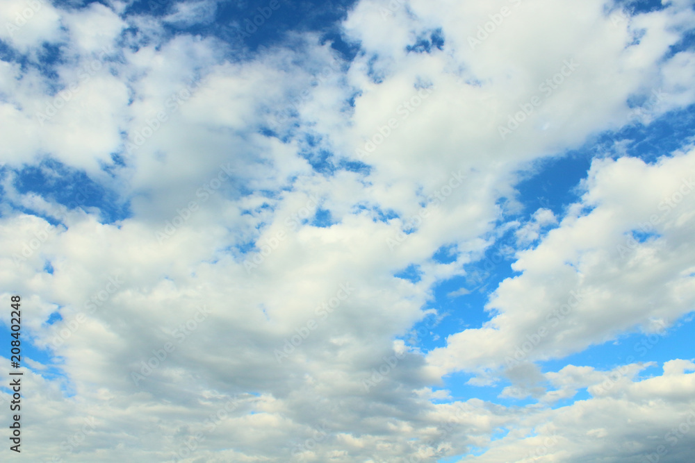 Fototapeta premium Beautiful blue sky and white fluffy cumulus clouds. Background. Landscape.