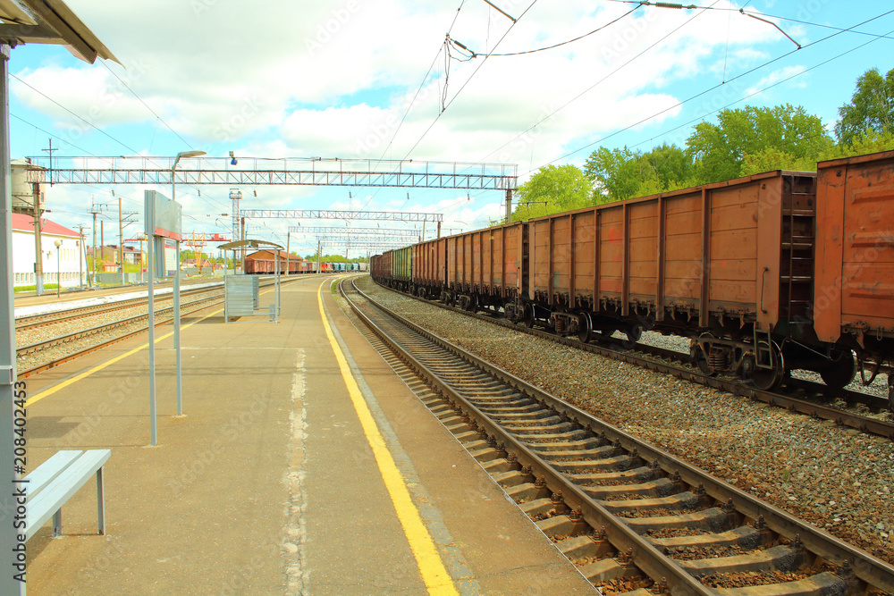 Freight railroad cars at the station. The train on the rails. Close-up. Freight railroad cars at the station. The train on the rails. Close-up.