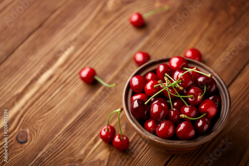Fresh red cherry on a dark wooden background. Cherries. Healthy food concept.