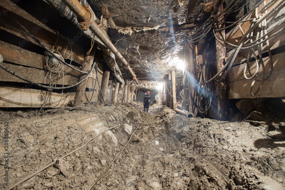 Underground emerald ore mine shaft tunnel gallery with light scraper