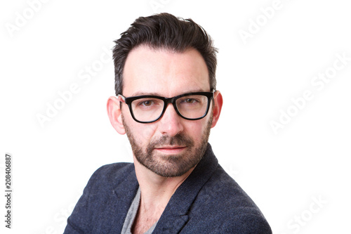 Close up serious man with beard and glasses posing against white background
