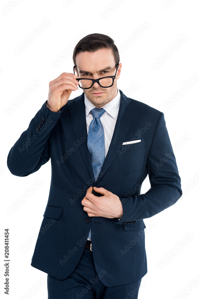 handsome businessman adjusting eyeglasses and looking at camera isolated on white handsome businessman adjusting eyeglasses and looking at camera isolated on white