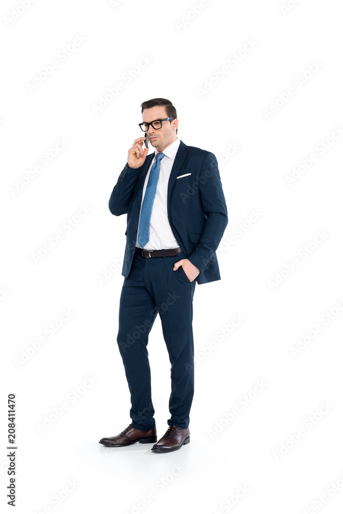 full length view of businessman in eyeglasses and suit talking by smartphone isolated on white full length view of businessman in eyeglasses and suit talking by smartphone isolated on white