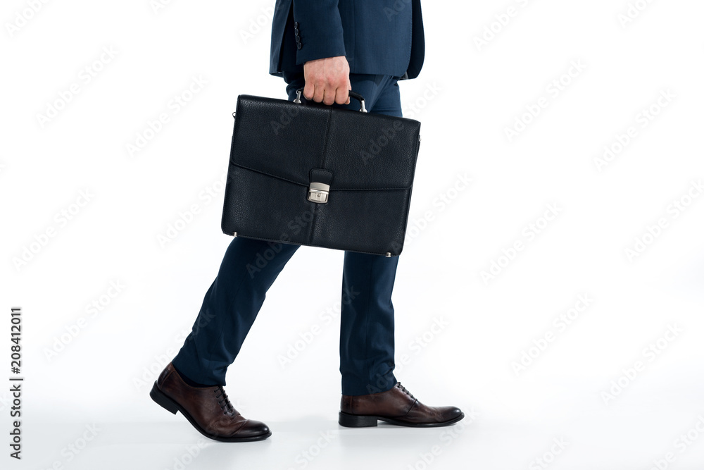 cropped shot of businessman holding briefcase and walking on white cropped shot of businessman holding briefcase and walking on white