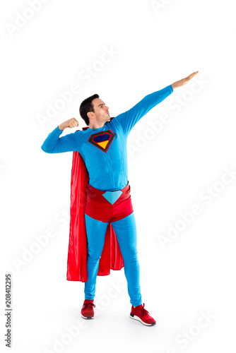 full length view of handsome man in superhero costume looking away isolated on white
