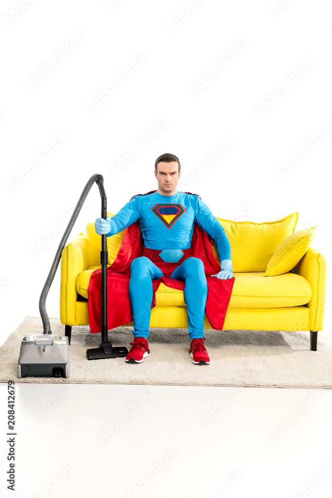 superman with vacuum cleaner sitting on couch and looking at camera on  white Stock Photo | Adobe Stock