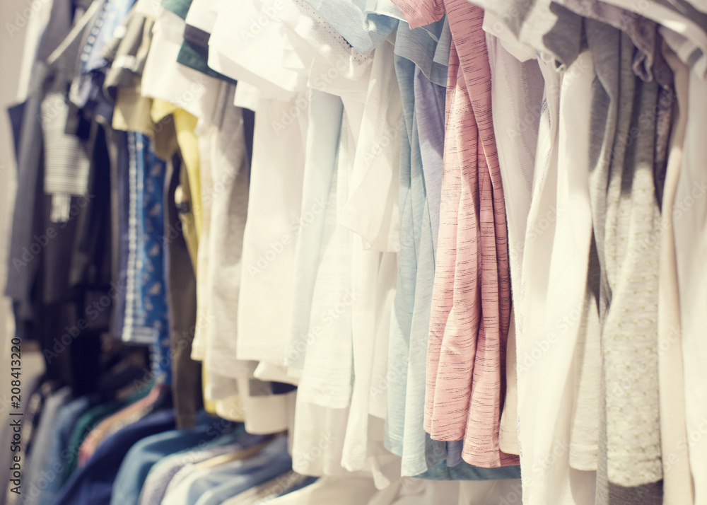 Various women's clothing of different flowers and styles on a hanger in shop, selective focus Various women's clothing of different flowers and styles on a hanger in shop, selective focus