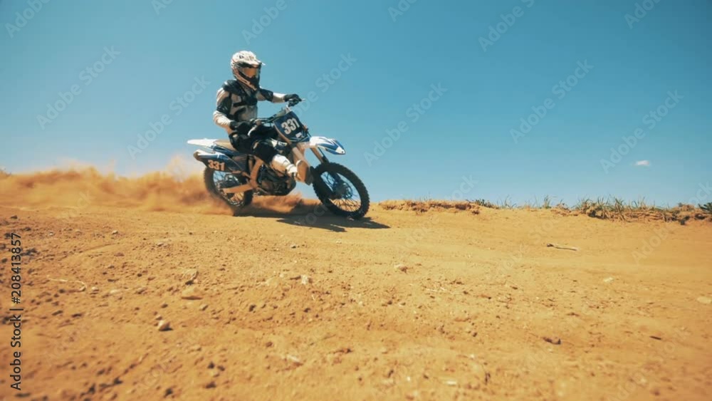 Dusty landscape with a racer on his autobike riding through Dusty landscape with a racer on his autobike riding through