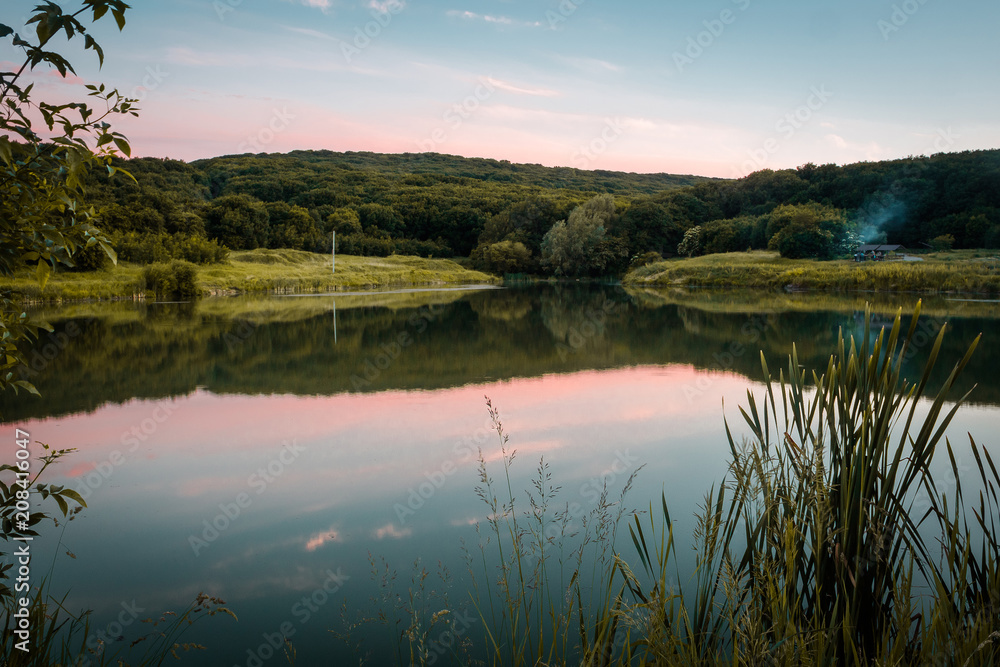 Sunset on a lake located around the forest Sunset on a lake located around the forest