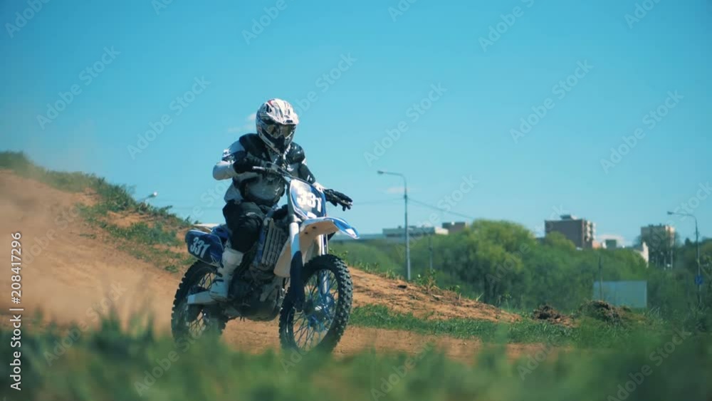 Sportbike with its pilot is riding down the hill Sportbike with its pilot is riding down the hill