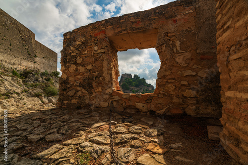 The medieval castle of Xativa against a dramatic and bright sky after the rain. District of Valencia. Spain photo