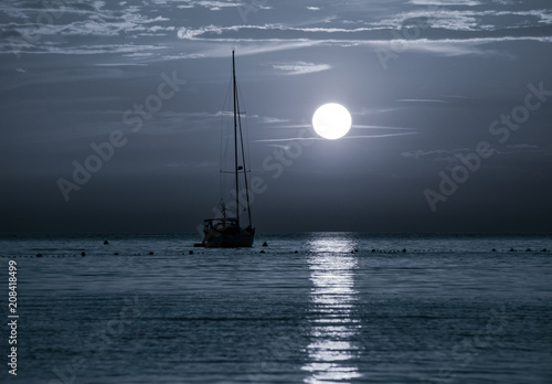 Beautiful night Adriatic sea, yacht and full moon, Croatia. Night seascape. 