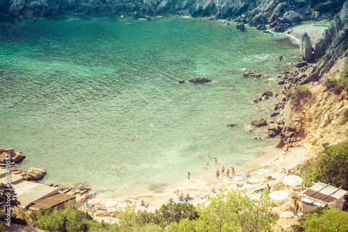 Ibiza, Spain, August 27, 2017: Ibiza natural beach view with some tourists during summer. photo