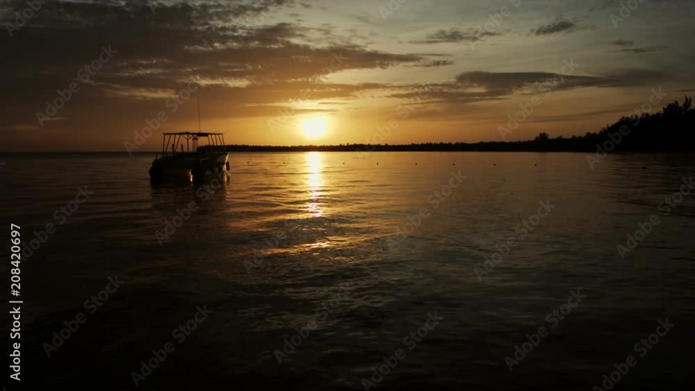 The boat rocks on the waves in the rays of the sunset The boat rocks on the waves in the rays of the sunset