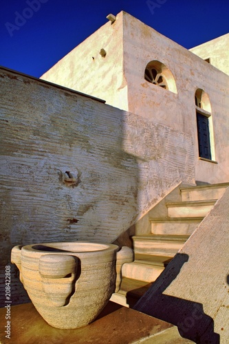 Exterior view of old building with marble decorative elements in Isternia village, Tinos island, Cyclades, Greece. photo