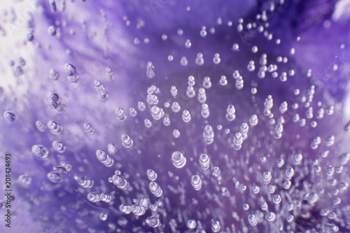 Airy delicate bubbles flowing through ice with purple colors underneath 3