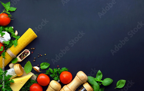Food background, ingredients for cooking dinner. spaghetti, vegetables, sauces and spices,dark background . copy space. top view.