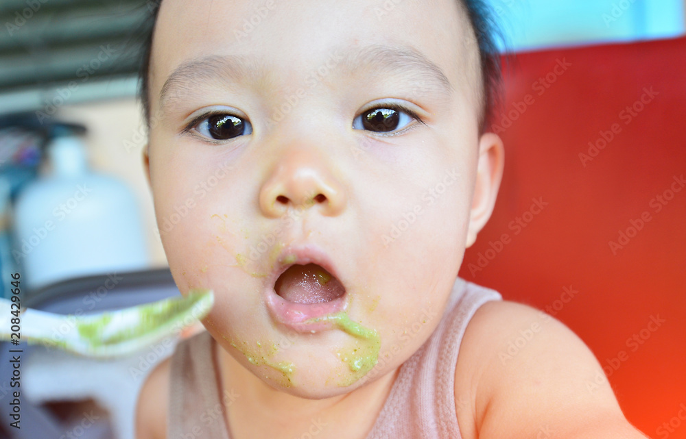 Face and gesture expression of Asian babies during eating time. Face and gesture expression of Asian babies during eating time.