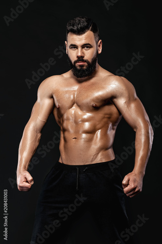 strong bodybuilder posing in studio © producer