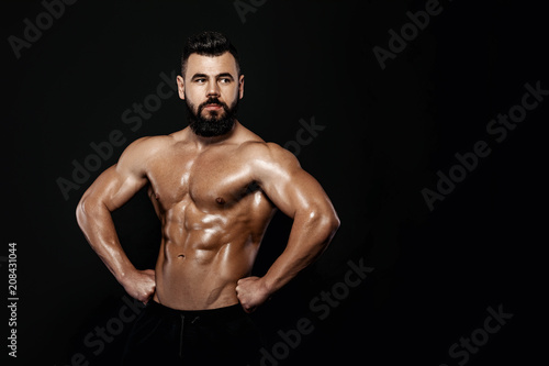 strong bodybuilder posing in studio