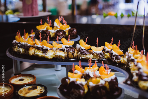 Closeup of sweet tasty dessert on modern table buffet. tiramisu dessert in glass.