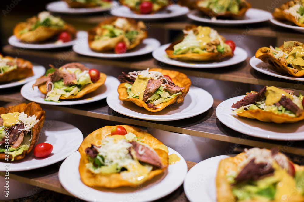Mexican burrito in tortilla shells with fresh tomatoes, cheese and lettuce Mexican burrito in tortilla shells with fresh tomatoes, cheese and lettuce