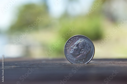 Coin with blur background sitting on a wooden floor