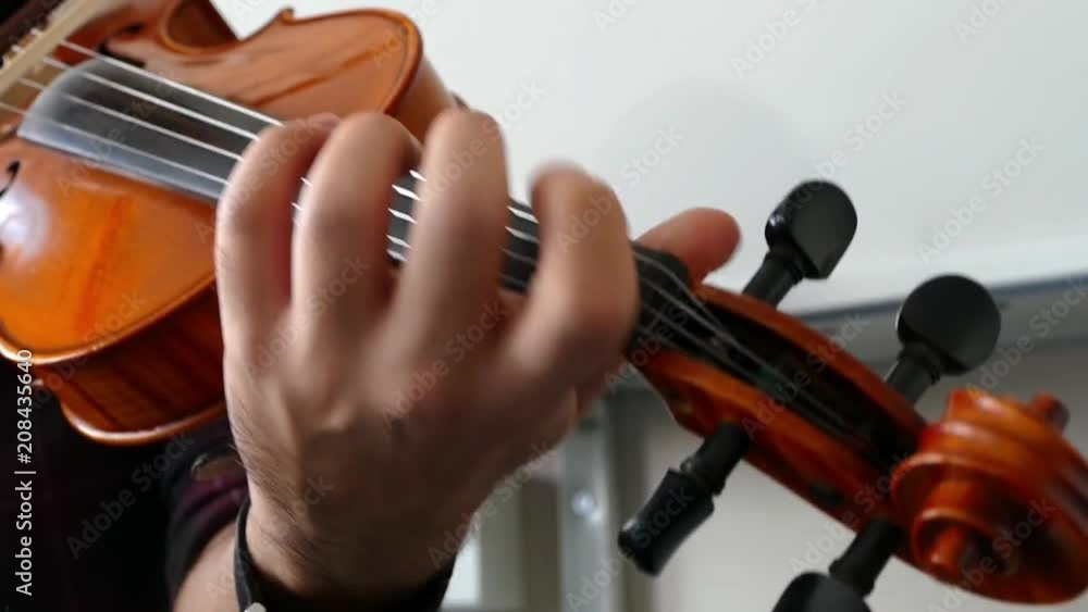 Violinist playing the violin at the school, teaches notes,classic turkish music.
Violinist playing the violin at the school, teaches notes,classic turkish music.