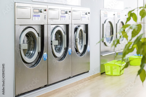Fotografia Public laundry with modern, silver washing machines