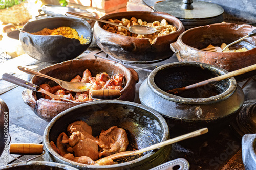 Traditional Brazilian food off the rgion off Minas Gerais being prepared in clay pots and in the old and popular wood stove photo