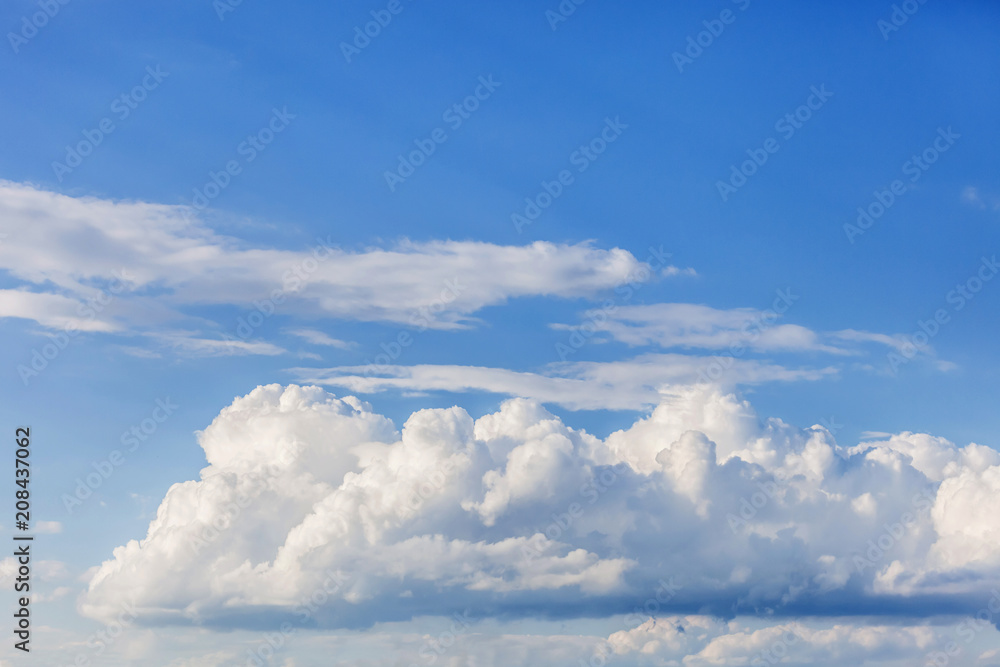 Blue sky with white puffy clouds. Clouds in the blue sky.