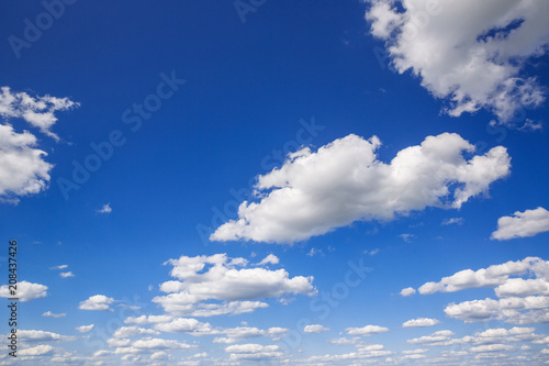 Blue sky with white puffy clouds. Clouds in the blue sky.