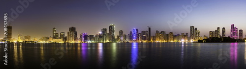 Panoramic view of Sharjah waterfront cityscape in UAE at dusk © creativefamily