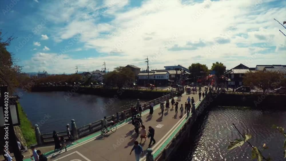 Hikone Japan, crowds walk across castle moat to view the sights of the yearly Hikone Mascot festival. Hikone Japan, crowds walk across castle moat to view the sights of the yearly Hikone Mascot festival.