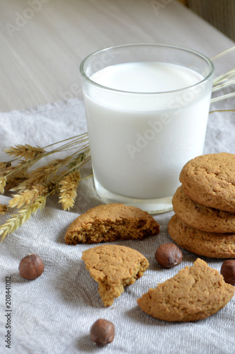 milk, oatmeal cookies and nuts on the table