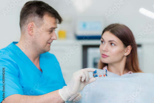 orthodontist will explain to the patient how the plate aligns the teeth