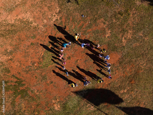 Aerial view of children playing with teachers of 
