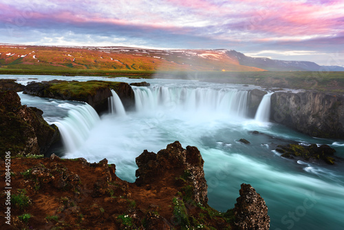 Colorful sunrise on Godafoss waterfall on Skjalfandafljot river, Iceland, Europe