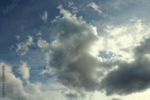 Beautiful blue sky and gray cumulus clouds. Natural appearance. Landscape. Background.