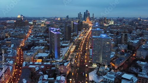 Bright lights of night Moscow from bird's eye view. Intensive traffic at New Arbat street in the heart of the city. Multistory houses illuminated with neon lights on the sides of the wide avenue. © railwayfx