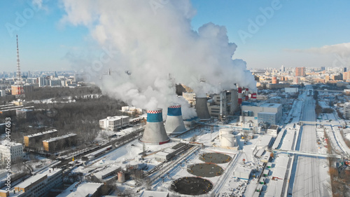 Smooth aerial shot around industrial factory chimney, dense fume comes out of the Moscow power plant pipe, air pollution sunny scene, global warming, nuclear ecology pollution.