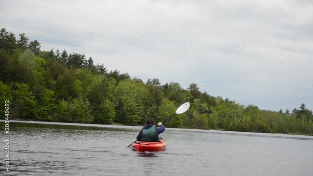 Young Woman Kayaking on a Lake Young Woman Kayaking on a Lake