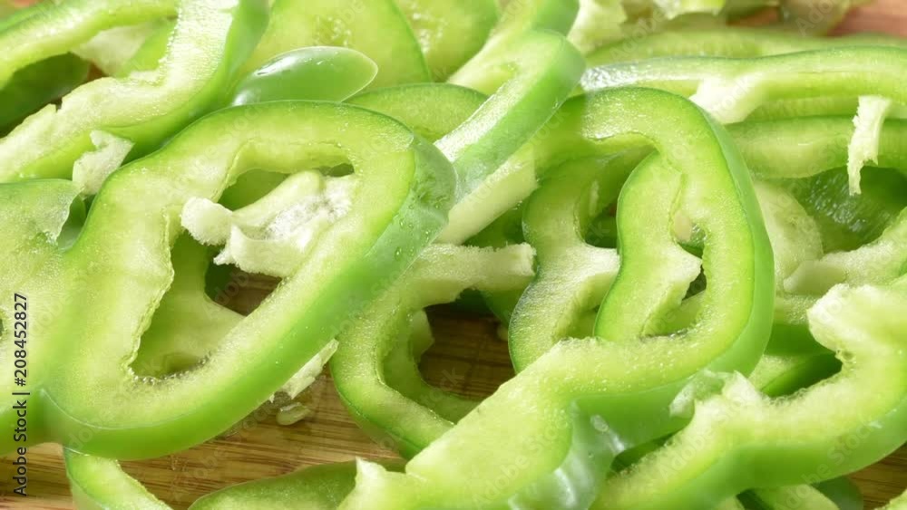 Thin sliced green peppers on a cutting board Thin sliced green peppers on a cutting board