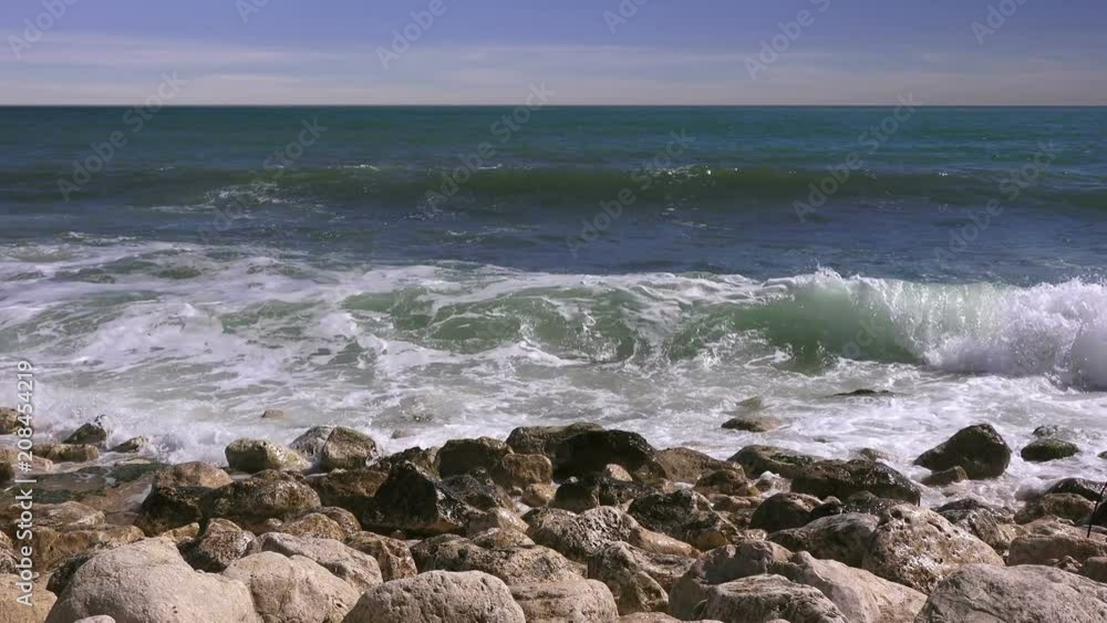 Close-up of sea stones against the background of a stormy sea Close-up of sea stones against the background of a stormy sea