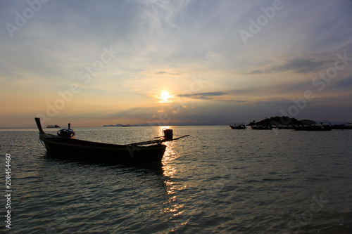 Sunrise in the morning, beautiful seafaring sky with beautiful long tail boat in the sea. © montri999