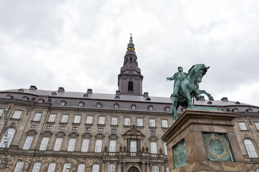 Storm clouds over the Christiansborg Palace and Frederik VII statue.