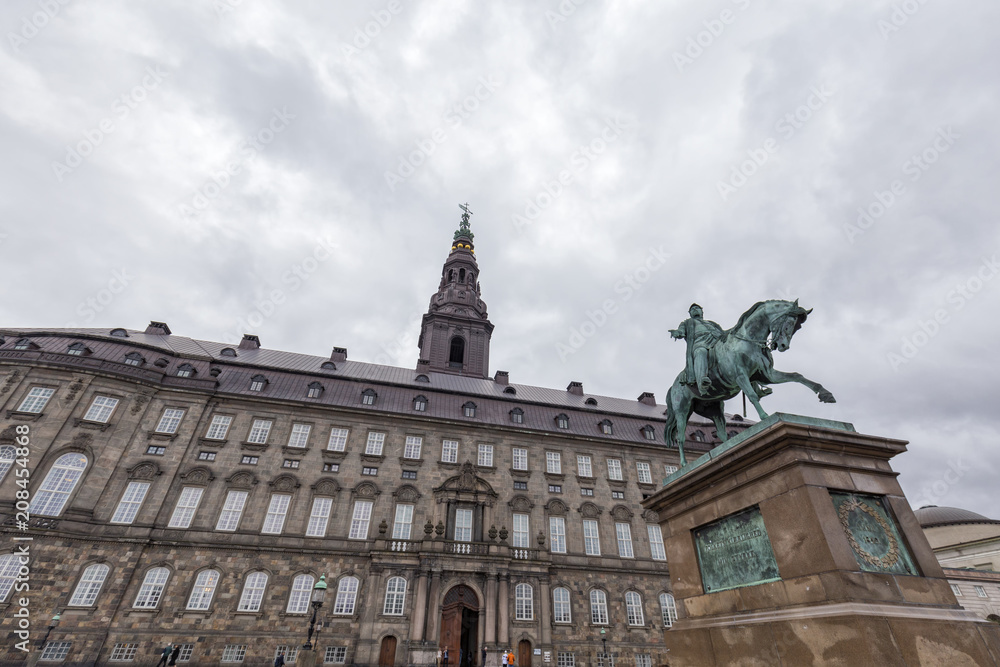 Looking up at the Christiansborg Palace and Frederik VII statue in Copenhagen, Denmark.