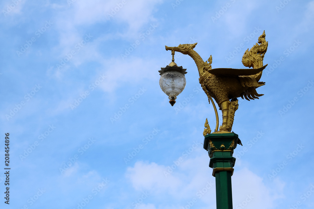 Light poles with beautiful asian-style design on the street against a blue sky