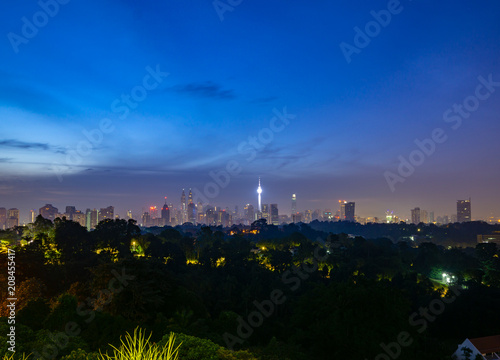 Canvas Print Cloudy sunrise over KL Tower and surrounded buildings in downtown Kuala Lumpur, Malaysia