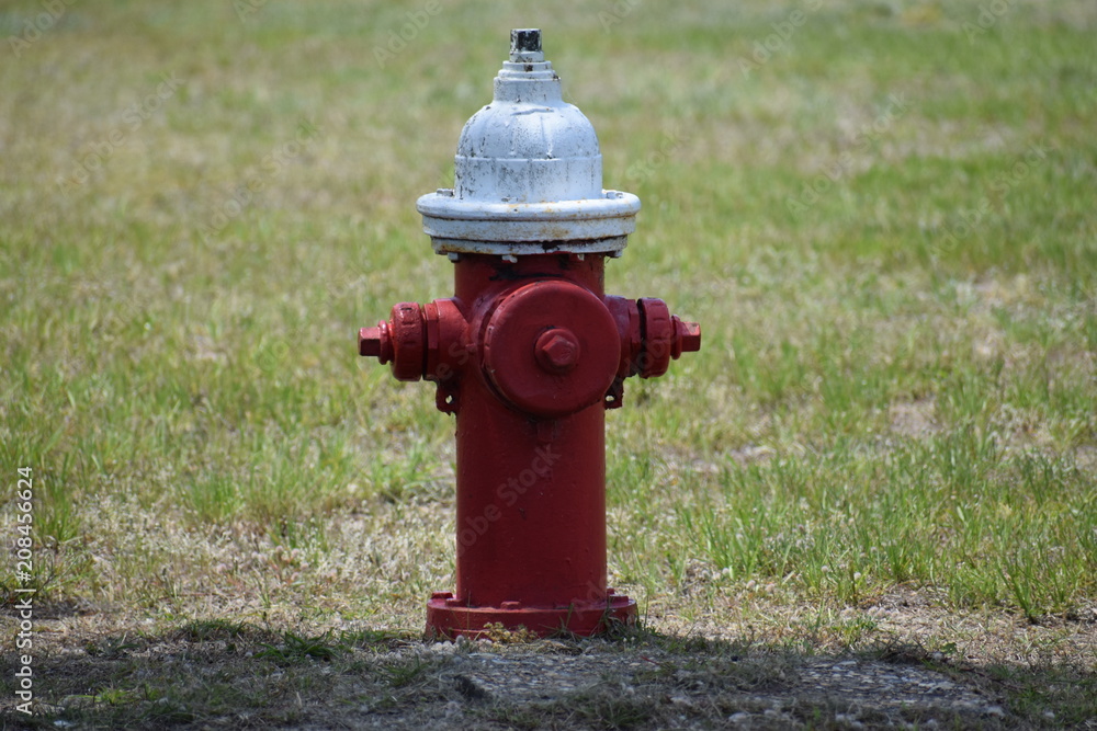 Red fire hydrant with white cap and some rust Red fire hydrant with white cap and some rust